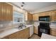 Well-lit kitchen with wooden cabinets and black appliances at 513 Sun Catcher Dr, Avon, IN 46123