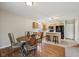 Eat-in kitchen area with bar seating and black appliances, seamlessly connected to the dining space at 513 Sun Catcher Dr, Avon, IN 46123