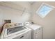 Well-lit laundry room equipped with a washer and dryer and a wire shelf at 513 Sun Catcher Dr, Avon, IN 46123