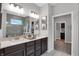 Bright bathroom with a double vanity, tiled floors, and glass shower at 5273 Nettleton Way, Avon, IN 46123