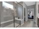 Modern bathroom featuring a glass-enclosed shower with a built-in bench and gray tiled walls at 5273 Nettleton Way, Avon, IN 46123