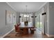 Bright dining area featuring a wooden table, stylish chandelier, and large windows at 5273 Nettleton Way, Avon, IN 46123