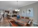 Open concept dining area with modern table, bench seating, and kitchen view at 5273 Nettleton Way, Avon, IN 46123