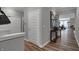 Hallway with wood floors, modern art, and access to multiple rooms at 5273 Nettleton Way, Avon, IN 46123