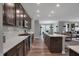 Open kitchen with a large island, modern appliances, and a seamless flow into the living area at 5273 Nettleton Way, Avon, IN 46123