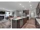 Modern kitchen with a central island, stainless steel appliances, and an open view to the living room at 5273 Nettleton Way, Avon, IN 46123