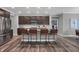 Well-lit kitchen showcasing an island with barstools, stainless steel fridge, and plenty of counter space at 5273 Nettleton Way, Avon, IN 46123