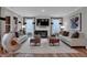 Bright living room with large windows, modern fireplace, and comfortable seating arrangement at 5273 Nettleton Way, Avon, IN 46123