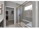 Walk-in shower featuring gray tiling, built-in bench and glass enclosure at 5273 Nettleton Way, Avon, IN 46123