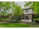 Wide view of the backyard with pond, stone wall, mature trees and outdoor patio at 5326 White Marsh Ln, Indianapolis, IN 46226
