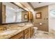 Bathroom with double sink vanity, framed mirror, tile floor, and accessible handrail, blending style and functionality at 5326 White Marsh Ln, Indianapolis, IN 46226