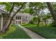 Landscaped front yard and walkway of a well-maintained home, framed by mature trees and greenery at 5326 White Marsh Ln, Indianapolis, IN 46226