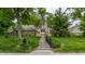Charming home exterior with well-manicured lawn, walkway, and mature trees in a peaceful setting at 5326 White Marsh Ln, Indianapolis, IN 46226