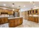 Well-lit kitchen featuring custom wood cabinets, stainless steel appliances, and spacious island with granite countertop at 5326 White Marsh Ln, Indianapolis, IN 46226