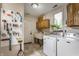 Well-organized laundry room with washer, dryer, utility sink, storage cabinets, and natural light from window at 5326 White Marsh Ln, Indianapolis, IN 46226