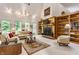 Bright living room featuring a fireplace with built-in bookshelves and large windows with natural light and neutral colors at 5326 White Marsh Ln, Indianapolis, IN 46226