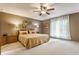 Comfortable bedroom with soft carpet, ceiling fan, ample lighting, and neutral tones, creating a relaxing retreat at 5326 White Marsh Ln, Indianapolis, IN 46226