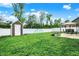 Spacious backyard with a shed, play equipment, and dining set under a canopy at 5420 Orwell Ct, Indianapolis, IN 46239