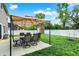 Cozy backyard featuring a patio with outdoor seating, grassy area, and storage shed, perfect for entertaining at 5420 Orwell Ct, Indianapolis, IN 46239
