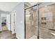 This bathroom features a tiled shower and a view into the attached bedroom with a carpeted floor at 5420 Orwell Ct, Indianapolis, IN 46239
