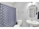 Cozy bathroom featuring a sleek sink and vanity, and a blue patterned shower curtain at 5420 Orwell Ct, Indianapolis, IN 46239