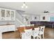 Bright dining area featuring a wood table, white chairs, and views of the staircase and living room at 5420 Orwell Ct, Indianapolis, IN 46239