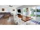 Inviting dining area flowing to a backyard, complete with a wood table, white chairs, and a comfortable living space at 5420 Orwell Ct, Indianapolis, IN 46239