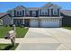 Beautiful two-story home featuring a manicured lawn, stone accents, and a two-car garage at 5420 Orwell Ct, Indianapolis, IN 46239