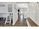 Hallway featuring a view into the playroom and a built-in bench and coat rack at 5420 Orwell Ct, Indianapolis, IN 46239