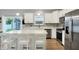 Modern kitchen featuring stainless steel appliances, an island with seating, white cabinets, and backyard access at 5420 Orwell Ct, Indianapolis, IN 46239
