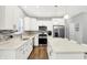 Modern kitchen featuring white cabinets, stainless steel appliances, an island with seating, and a stylish backsplash at 5420 Orwell Ct, Indianapolis, IN 46239
