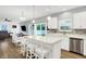 Bright, open-concept kitchen and dining area featuring white cabinets, a kitchen island with seating, and stainless appliances at 5420 Orwell Ct, Indianapolis, IN 46239