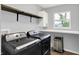 Bright laundry room with modern appliances and ample shelving for storage at 5420 Orwell Ct, Indianapolis, IN 46239