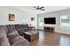 Cozy living room featuring a large sofa, hardwood flooring, and natural light at 5420 Orwell Ct, Indianapolis, IN 46239