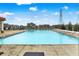 Large community swimming pool surrounded by a fence, with plenty of lounge chairs for relaxing at 5420 Orwell Ct, Indianapolis, IN 46239