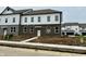 New two-story townhouse with brick and white siding and a walkway leading to the front door at 6248 Cascades Dr, Whitestown, IN 46075