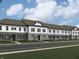 Charming townhome featuring a neutral brick and white siding exterior with black shutters and modern design elements at 6248 Cascades Dr, Whitestown, IN 46075