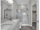 Bathroom boasts a double sink vanity with a tiled shower and glass enclosure at 633 Bridgeman Rd, Avon, IN 46123