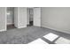 Bedroom with plush gray carpeting leads to a full bathroom featuring a shower at 633 Bridgeman Rd, Avon, IN 46123
