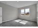 Bedroom has plush gray carpeting and a large window overlooking the outdoors at 633 Bridgeman Rd, Avon, IN 46123