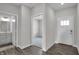 Bright entry foyer showcases a view into a bathroom, bedroom, and the front door with wood-look flooring at 633 Bridgeman Rd, Avon, IN 46123