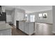 Open-concept kitchen with a center island, modern appliances, and access to the living area at 633 Bridgeman Rd, Avon, IN 46123