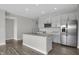 Bright, open kitchen showcasing white cabinetry, stainless steel appliances, and large center island at 633 Bridgeman Rd, Avon, IN 46123