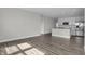 Bright living room with hardwood floors leading to the kitchen area with stainless steel appliances at 633 Bridgeman Rd, Avon, IN 46123