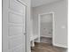 Mudroom with bench seating flows into utility room featuring laundry hookups and wire shelving at 633 Bridgeman Rd, Avon, IN 46123