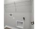 Utility room shows hookups for a washer and dryer, with a wire rack for storage at 633 Bridgeman Rd, Avon, IN 46123
