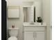 Modern bathroom with a white vanity, decorative mirror, and minimalist wall art at 647 Bridgeman Rd, Avon, IN 46123