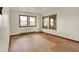 Bedroom with hardwood floors, multiple windows, and baseboard heating at 6580 N Us Highway 31, Whiteland, IN 46184