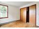 Bedroom featuring wooden floors and patterned wallpaper, featuring a closet at 6580 N Us Highway 31, Whiteland, IN 46184