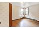 Bedroom with wooden floor and large window, featuring patterned wallpaper at 6580 N Us Highway 31, Whiteland, IN 46184